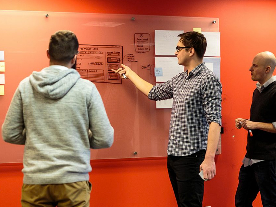 Chicago web design agency: employees looking at whiteboard