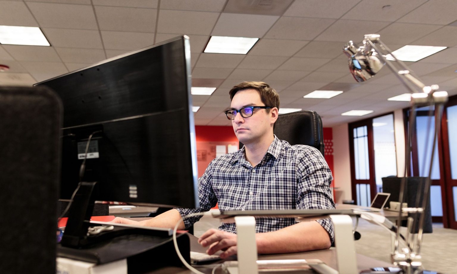 designer at his desk looking at the computer